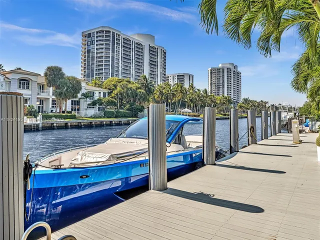 a dining room with furniture a chandelier and a floor to ceiling window