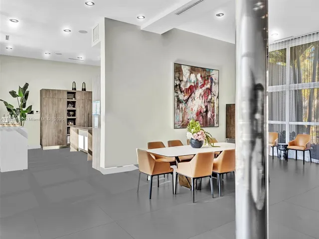 a bedroom with furniture and a large window