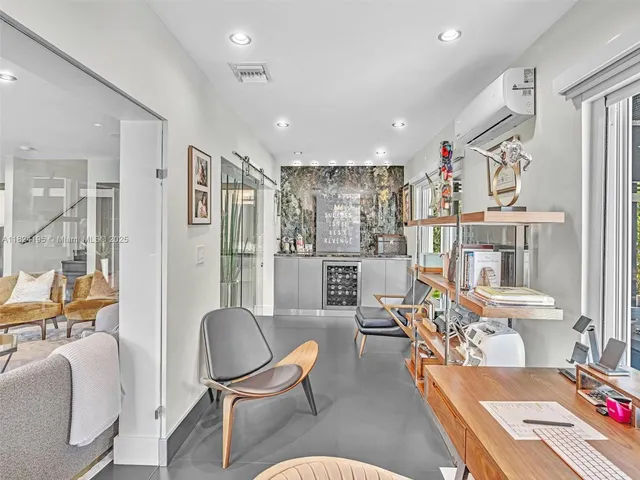 a living room with a couch and a potted plant