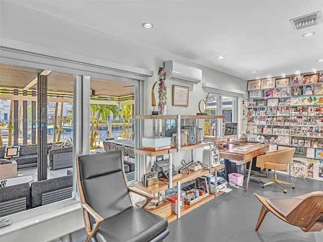 a view of living room with furniture and a mirror