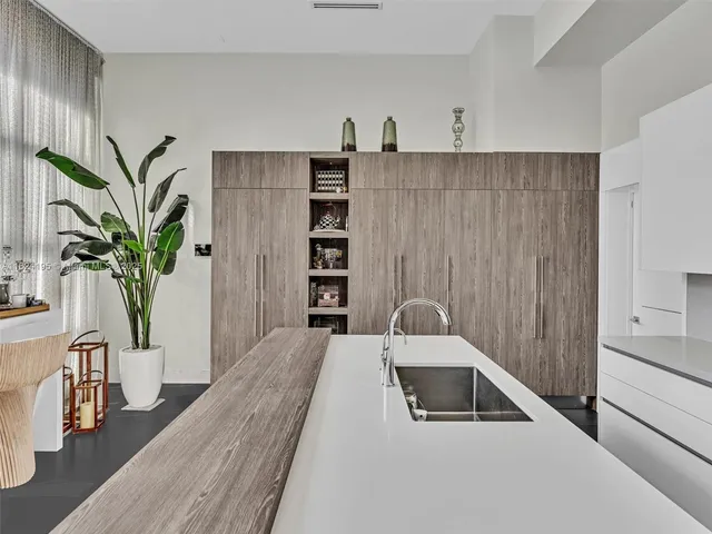 a bedroom with a bed a mirror and a table in it