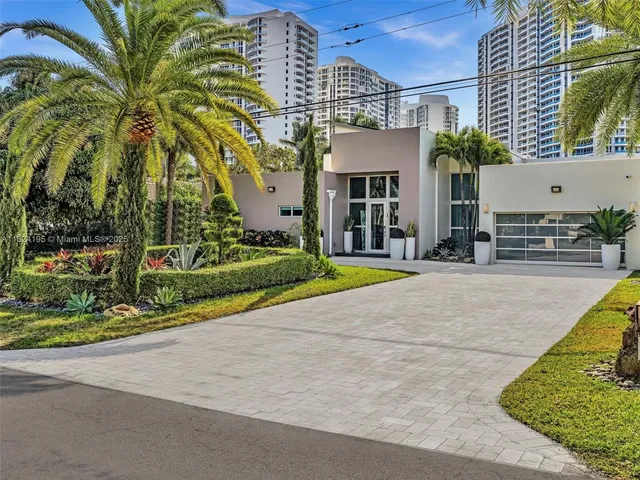 a view of a patio with a table and chairs under an umbrella