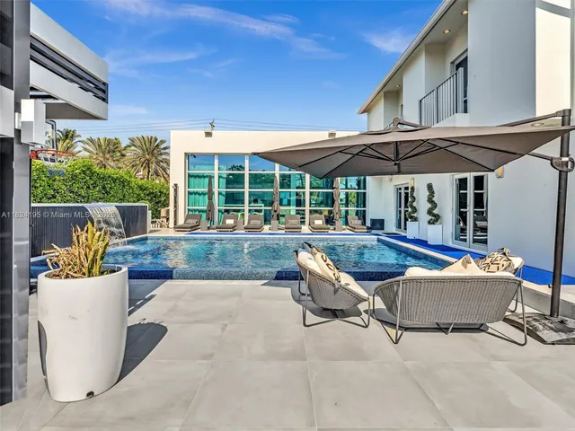 a view of a patio with a table and chairs