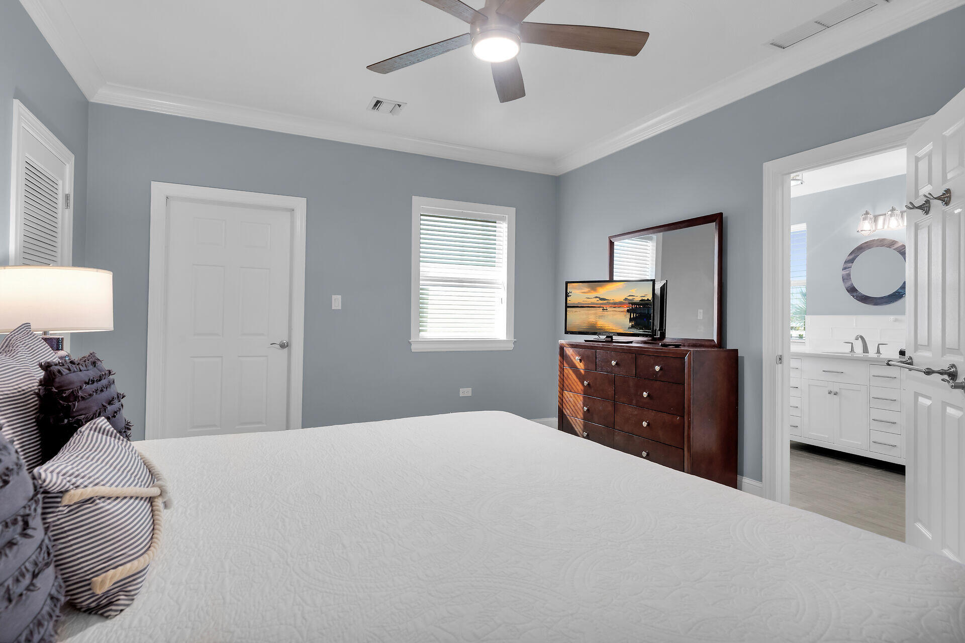 580-590 10th Street Key Colony Beach, FL 33051 - Photo 40 of 75 a bedroom with a bed and dresser with mirror