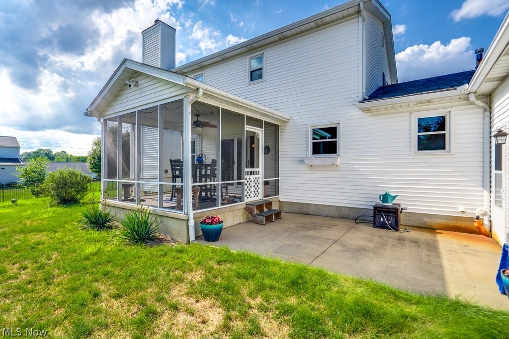 826 Stewart Road Kent, OH 44240 - Photo 6 of 43 Rear view of house with a yard, a sunroom, and a patio area