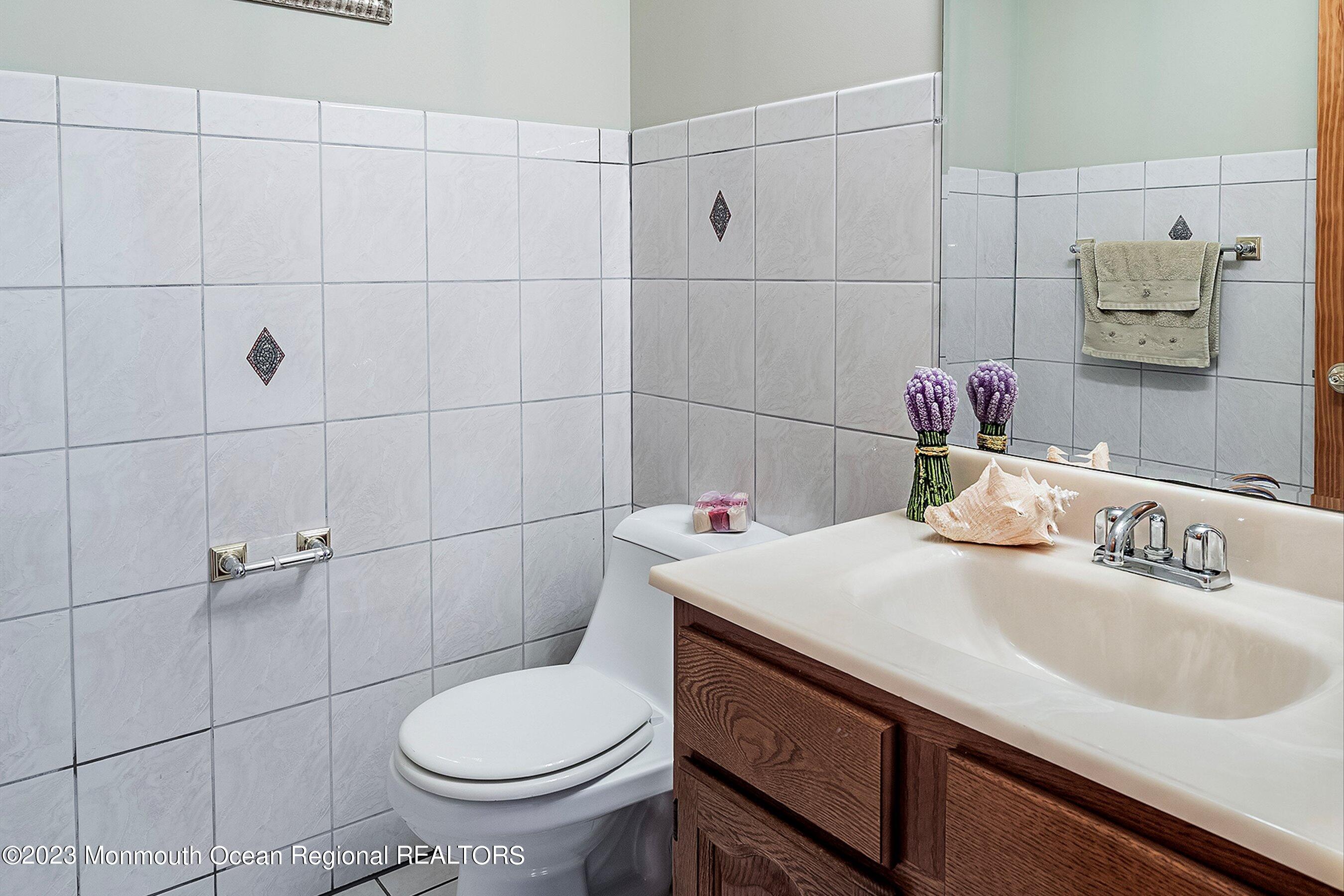 172 Jackson Mills Road Freehold, NJ 07728 - Photo 11 of 20 a bathroom with a sink toilet and a mirror