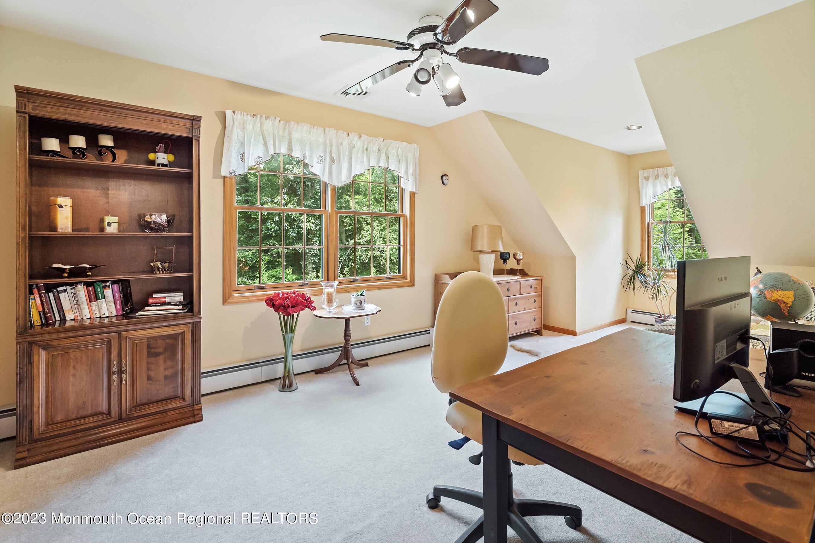 172 Jackson Mills Road Freehold, NJ 07728 - Photo 16 of 20 a living room with furniture a dining table and a floor to ceiling window