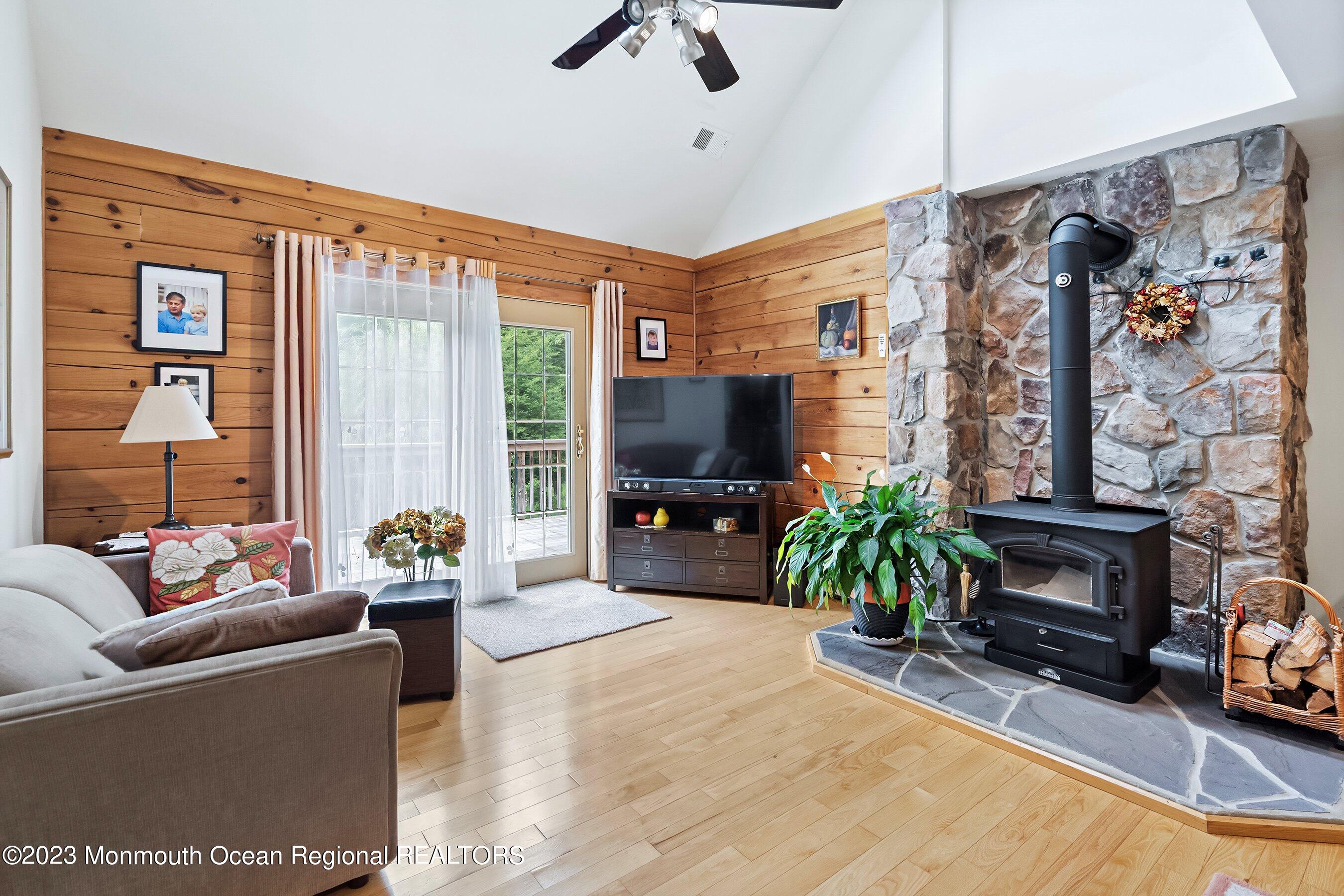 172 Jackson Mills Road Freehold, NJ 07728 - Photo 7 of 20 a living room with furniture a flat screen tv and a fireplace