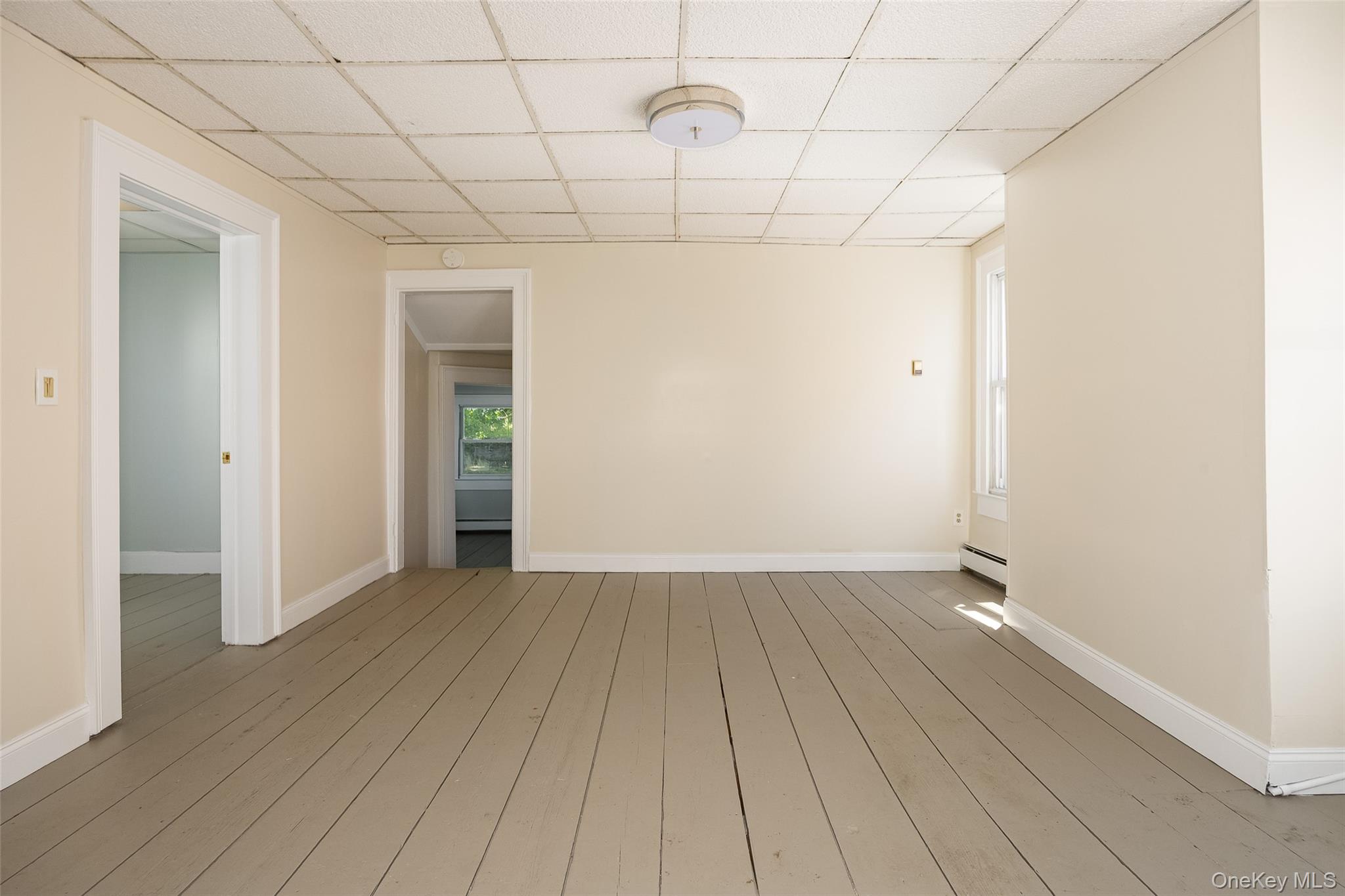 29 Delano Street, Unit 2 Poughkeepsie, NY 12601 - Photo 7 of 16 an empty room with wooden floor and natural light