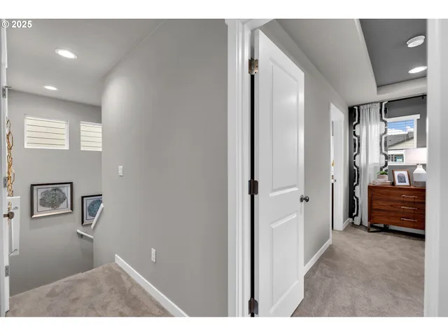 a view of a white house with a big yard