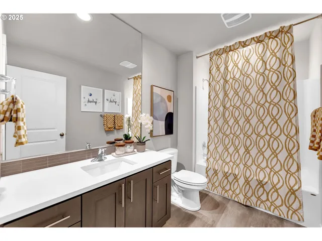 a bedroom with a bed and a painting on the wall