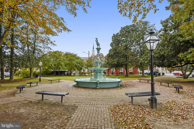 a garden with trees and a lake view
