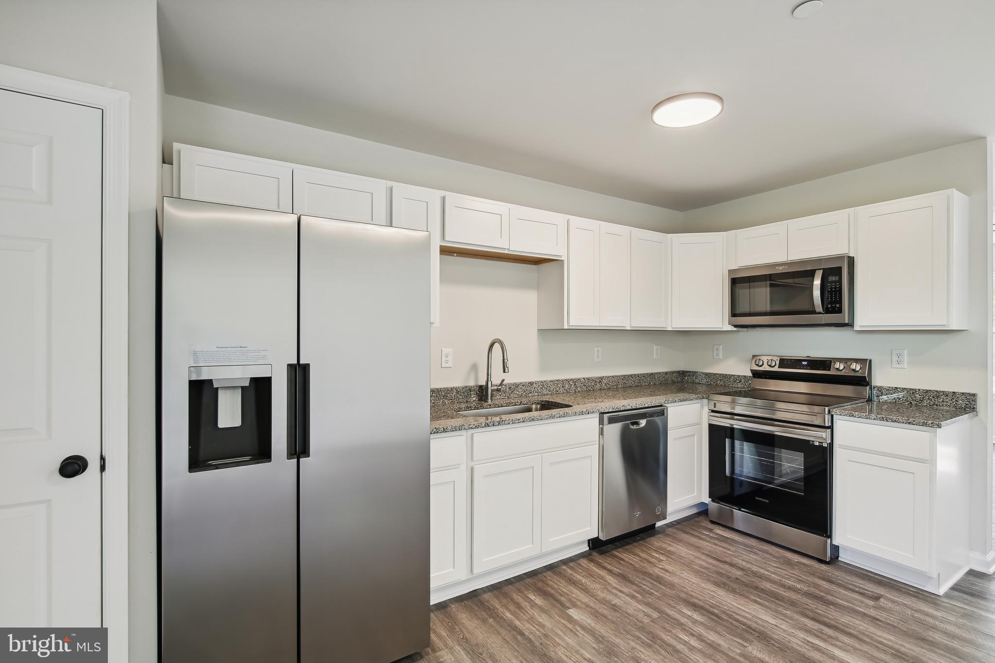 109 Metcalf Road Chestertown, MD 21620 - Photo 10 of 27 a kitchen with stainless steel appliances granite countertop a stove a sink and a refrigerator