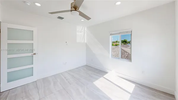 an empty room with windows and closet