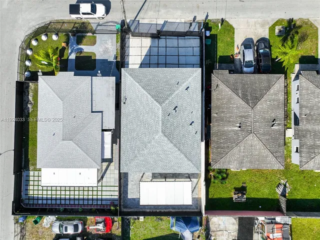 an aerial view of residential houses with outdoor space