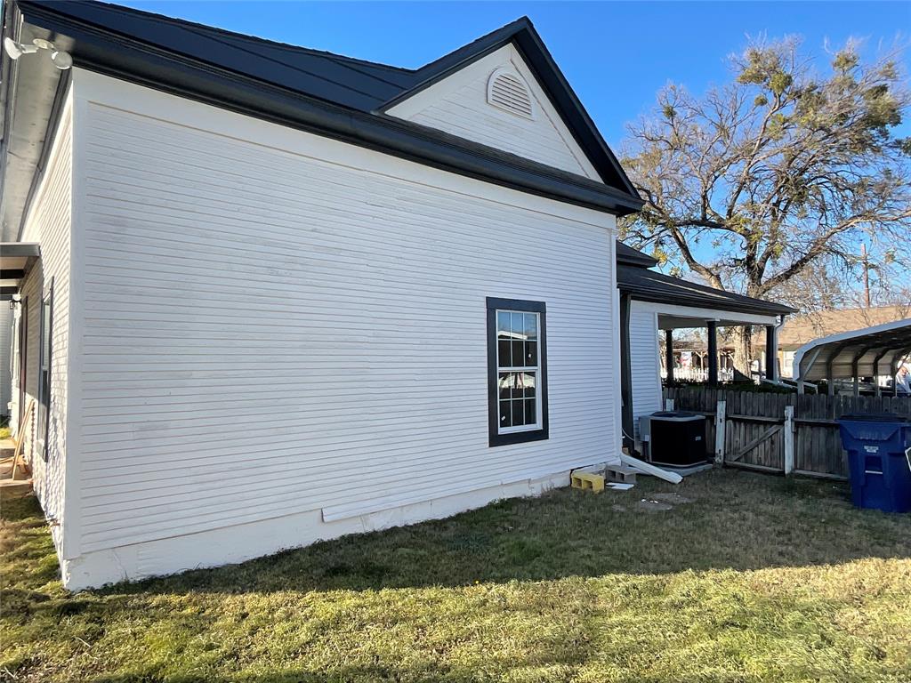 207 College Street Chico, TX 76431 - Photo 6 of 20 View of side of home with a gate and a central AC unit