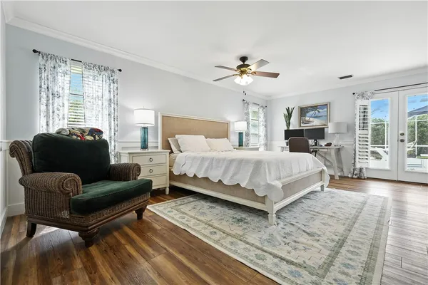 a bedroom with a large bed a couch and a window