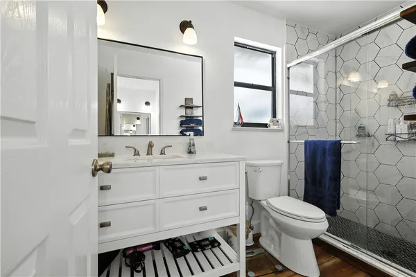 a bathroom with a sink mirror vanity and toilet