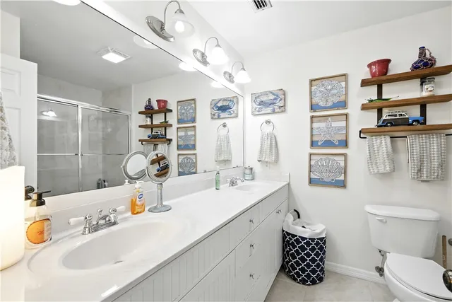 a bathroom with a sink double vanity and toilet