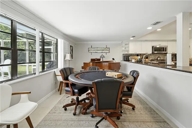 a view of a dining room with furniture and a window