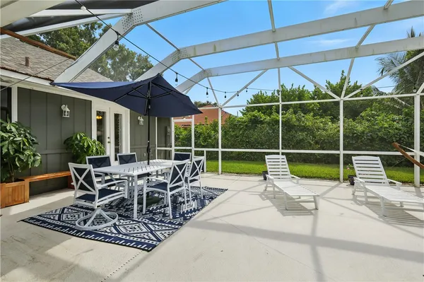 a view of a house with backyard sitting area and garden