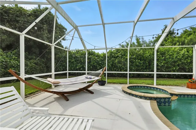 a view of swimming pool with couch and chairs