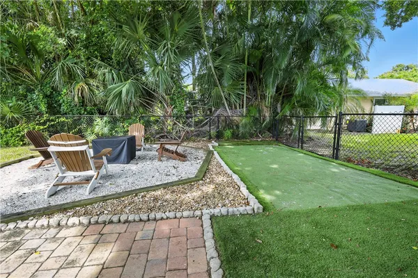 a view of a backyard with sitting area