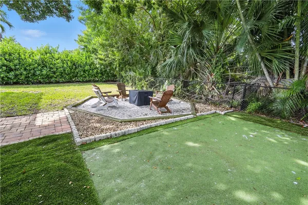 a view of a backyard with plants and a patio