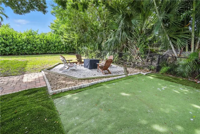 a view of a backyard with plants and a patio