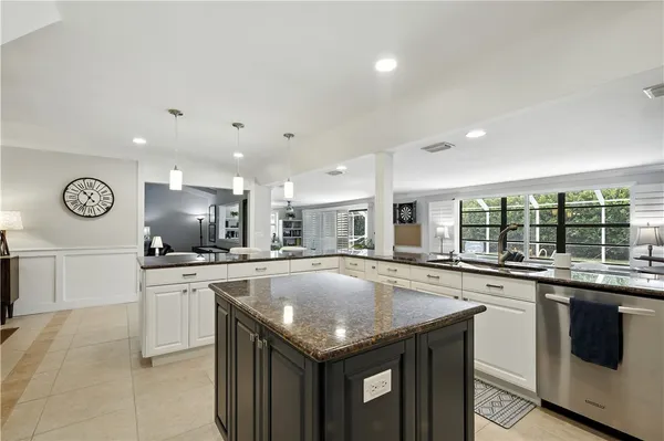 a kitchen with granite countertop stainless steel appliances a sink and cabinets