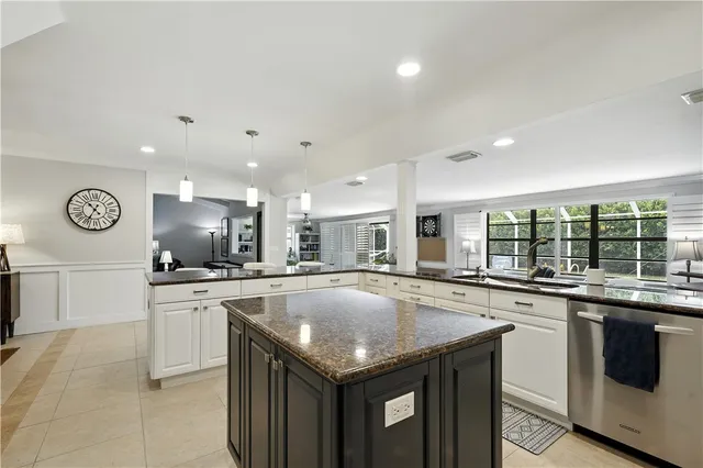 a kitchen with granite countertop stainless steel appliances a sink and cabinets