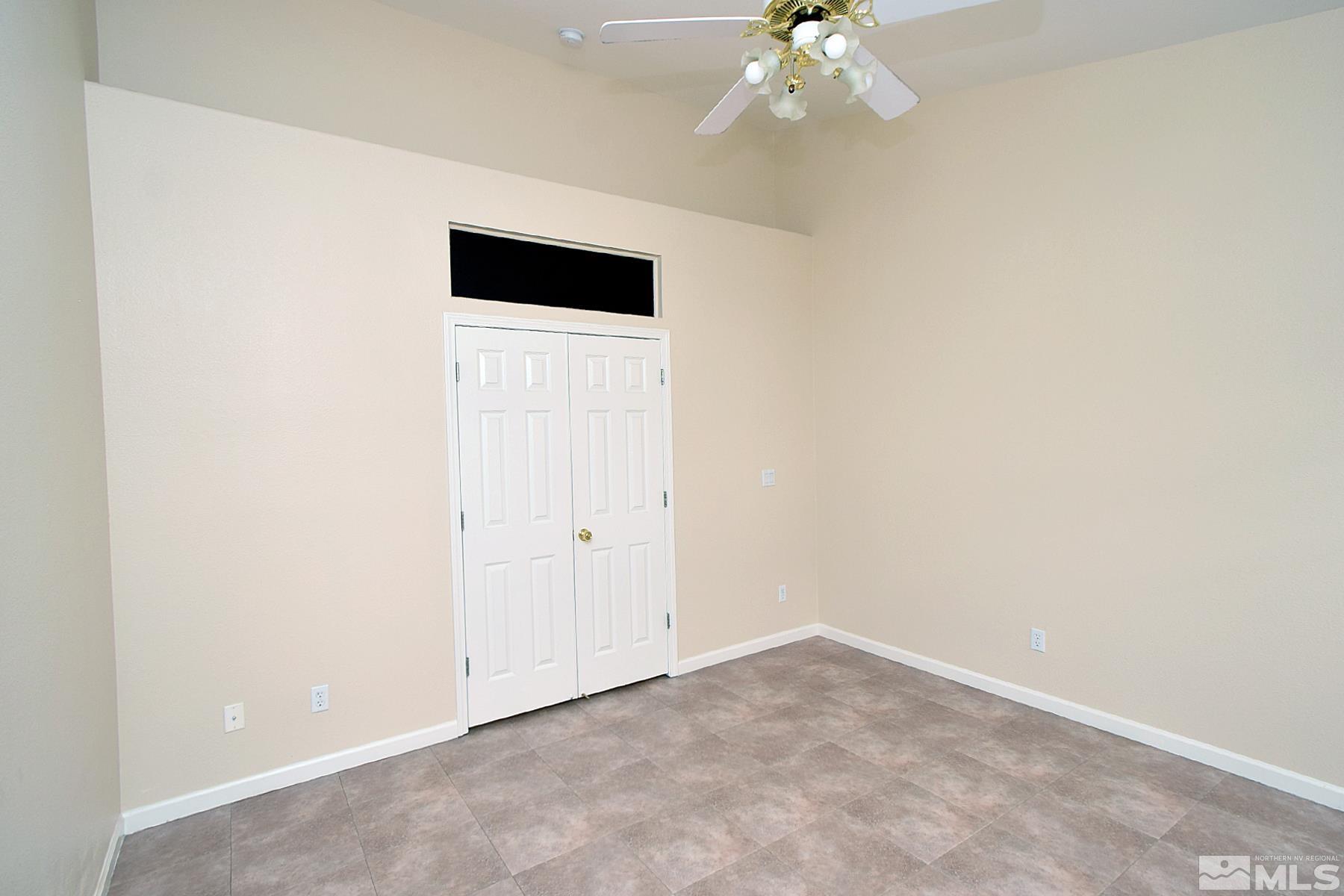 1201 Tule Drive Reno, NV 89521 - Photo 14 of 33 an empty room with a chandelier fan and entryway