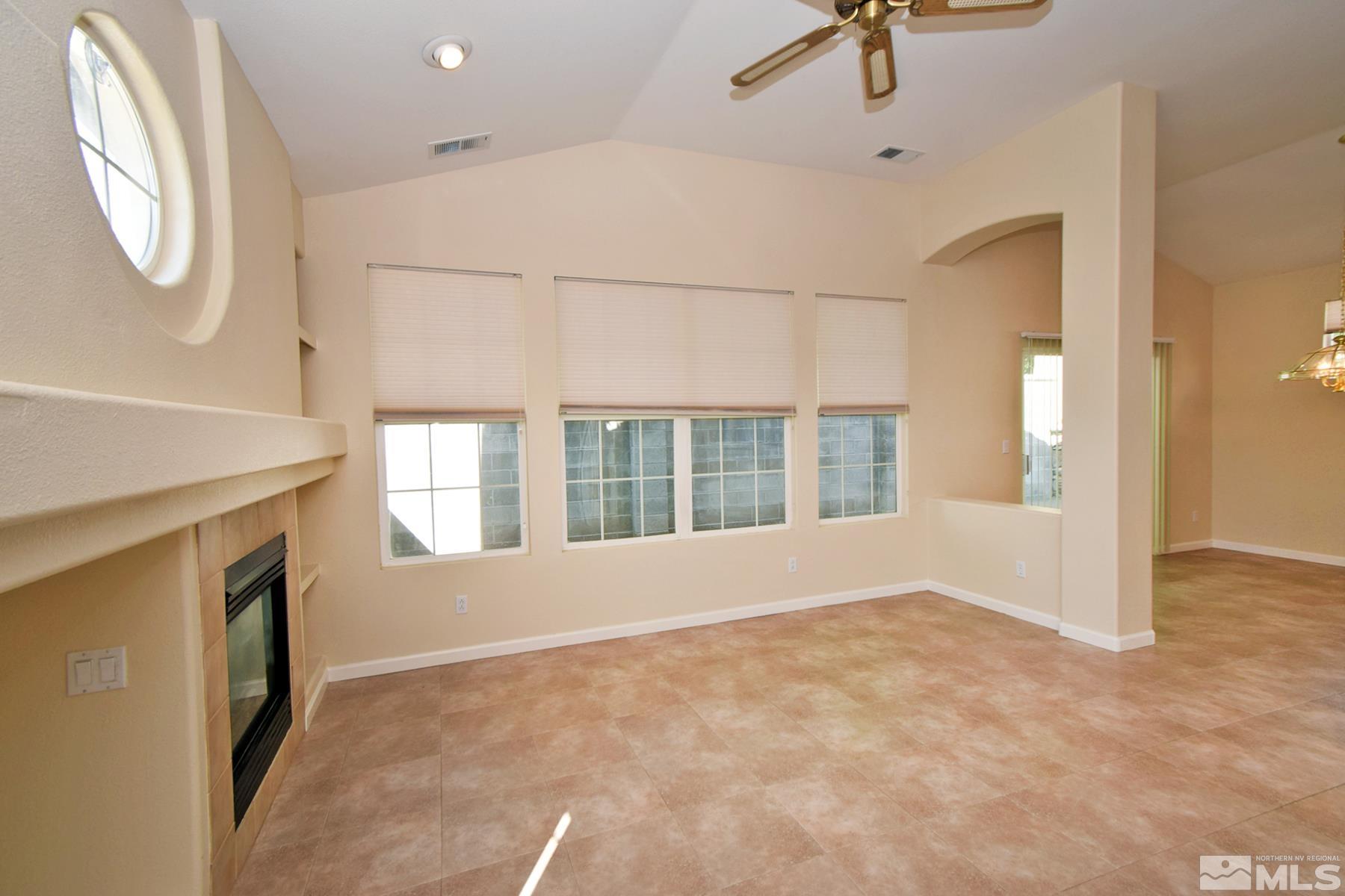 1201 Tule Drive Reno, NV 89521 - Photo 8 of 33 an empty room with windows and fireplace