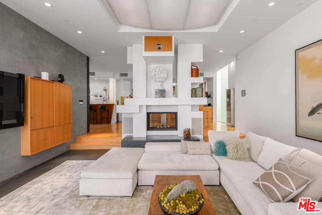 2238 Stradella Road Los Angeles, CA 90077 - Photo 16 of 54 a living room with furniture and a fireplace