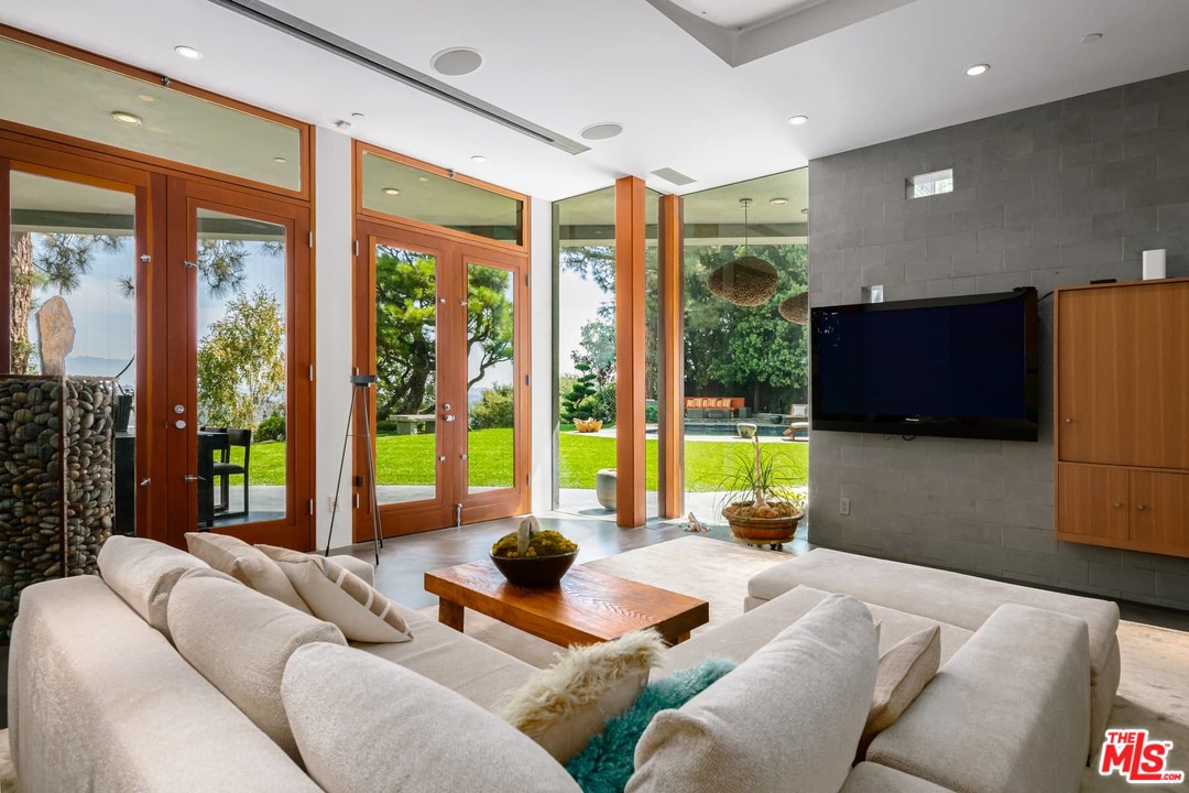 2238 Stradella Road Los Angeles, CA 90077 - Photo 17 of 54 a living room with furniture and a floor to ceiling window
