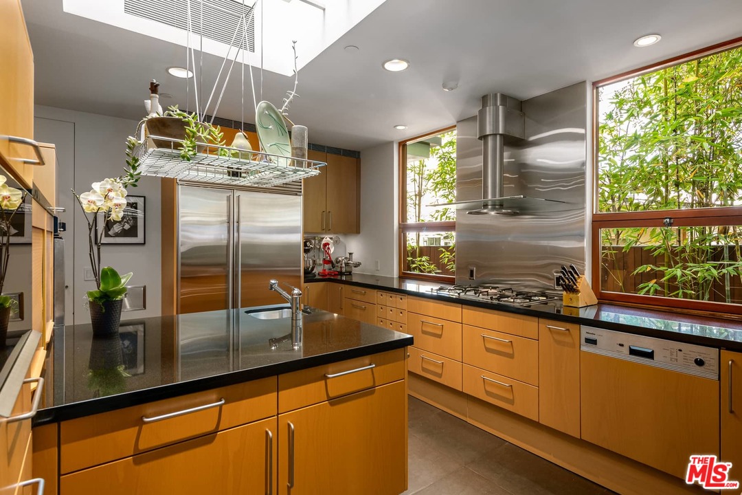 2238 Stradella Road Los Angeles, CA 90077 - Photo 19 of 54 a kitchen with stainless steel appliances granite countertop a sink a counter space and a window