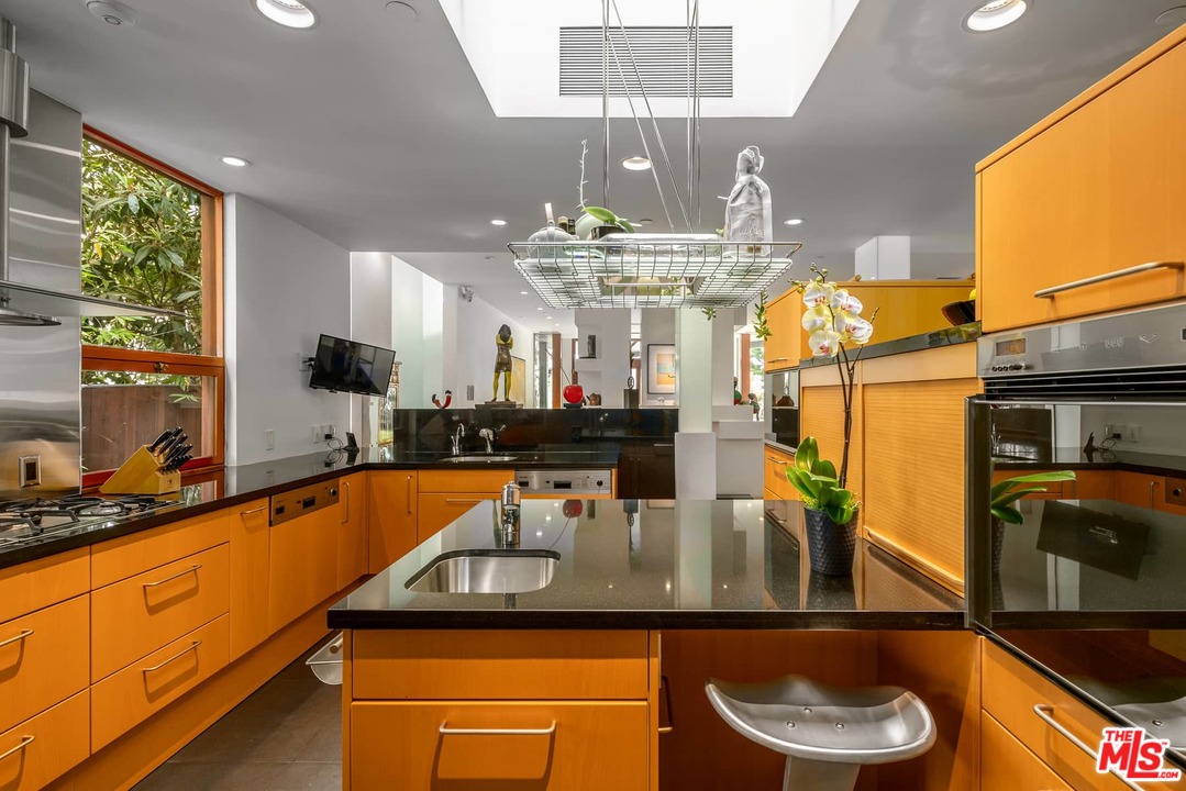 2238 Stradella Road Los Angeles, CA 90077 - Photo 20 of 54 a kitchen with stainless steel appliances granite countertop a sink and a counter top space