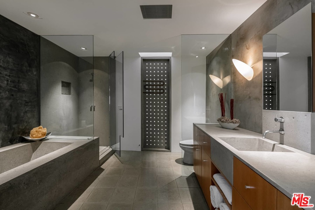 2238 Stradella Road Los Angeles, CA 90077 - Photo 26 of 54 a bathroom with a sink double vanity granite tub shower and a mirror