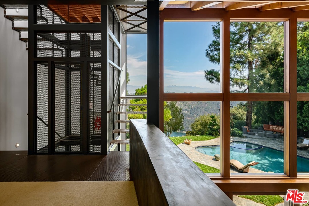 2238 Stradella Road Los Angeles, CA 90077 - Photo 30 of 54 a view of balcony and floor to ceiling window wooden floor