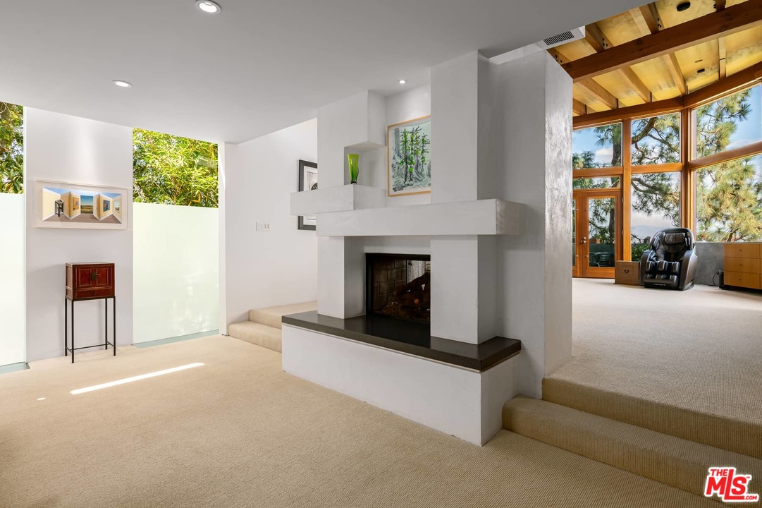 2238 Stradella Road Los Angeles, CA 90077 - Photo 32 of 54 a living room with furniture and a fireplace