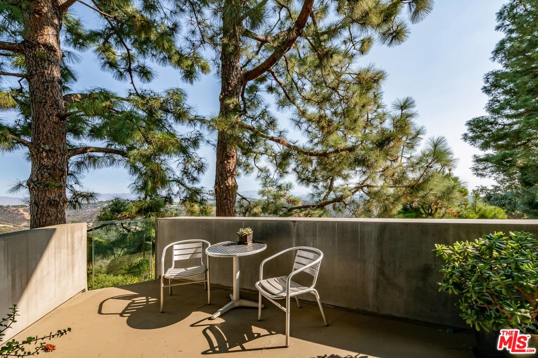 2238 Stradella Road Los Angeles, CA 90077 - Photo 35 of 54 a balcony with table and chairs