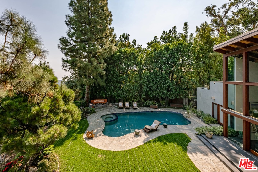 2238 Stradella Road Los Angeles, CA 90077 - Photo 36 of 54 a view of a swimming pool with sitting area