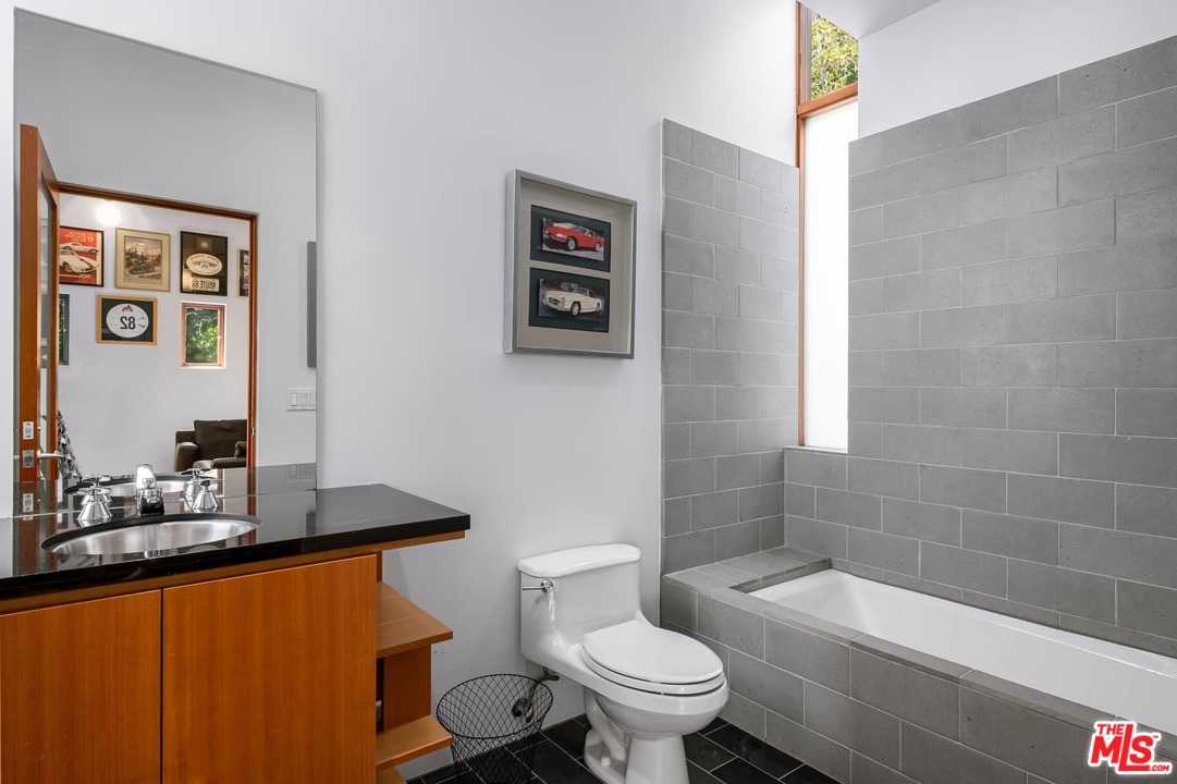 2238 Stradella Road Los Angeles, CA 90077 - Photo 43 of 54 a bathroom with a granite countertop toilet a sink and bathtub