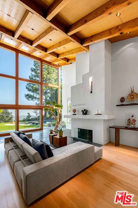 2238 Stradella Road Los Angeles, CA 90077 - Photo 6 of 54 a living room with furniture fireplace and large windows