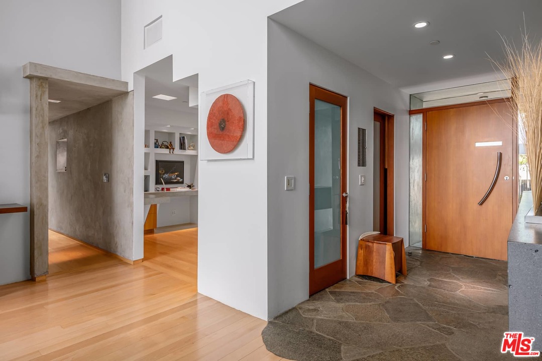 2238 Stradella Road Los Angeles, CA 90077 - Photo 9 of 54 a view of a hallway with bathroom and wooden floor