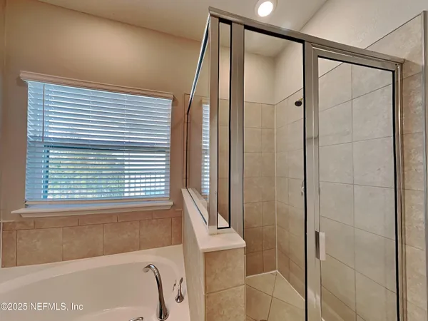 a bathroom with a bathtub and a shower