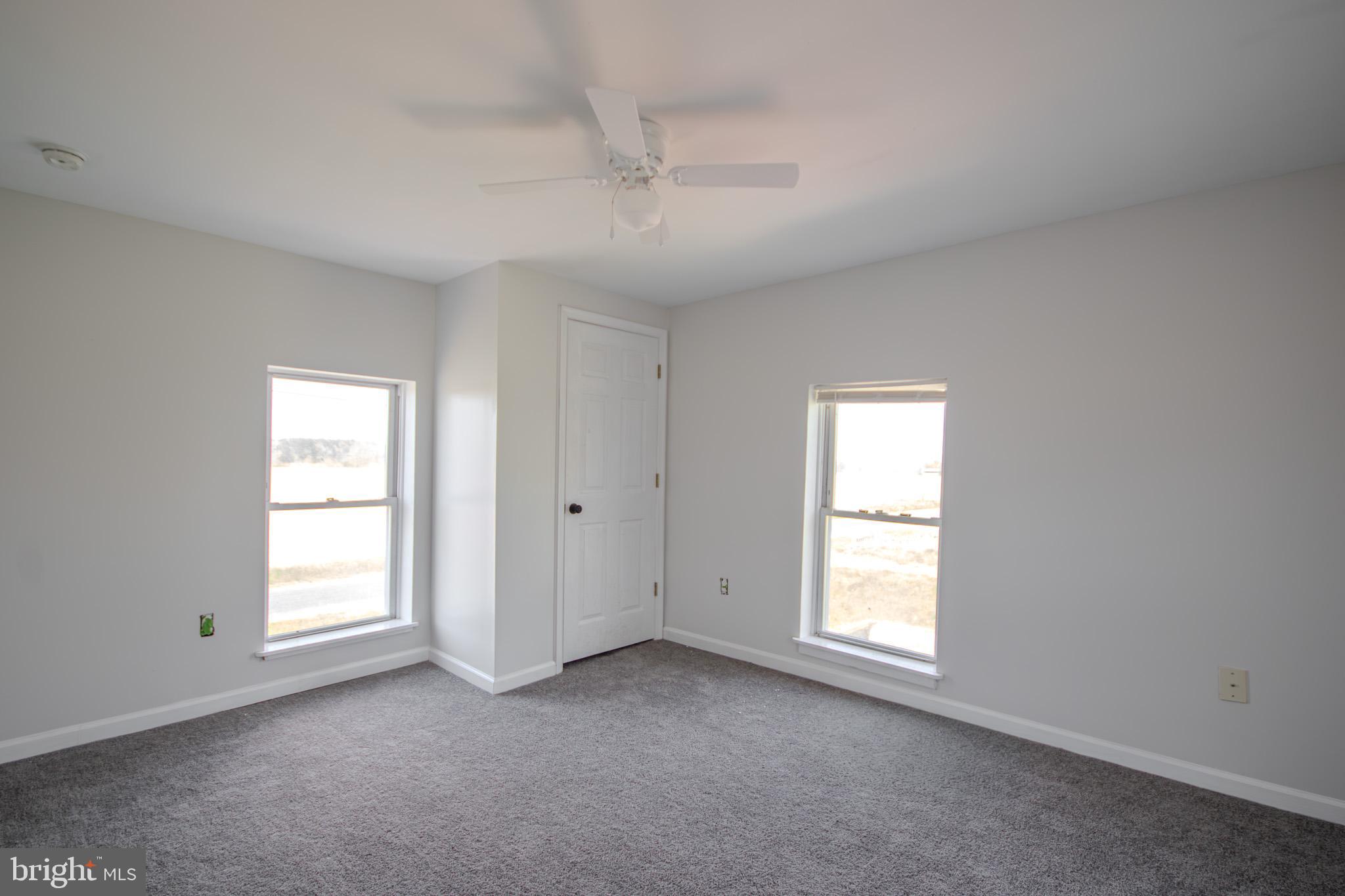 5693 Landon Store Road Marion Station, MD 21838 - Photo 15 of 20 an empty room with windows and closet