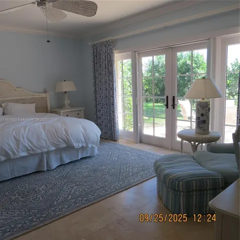 a bedroom with a bed a window and walk in closet