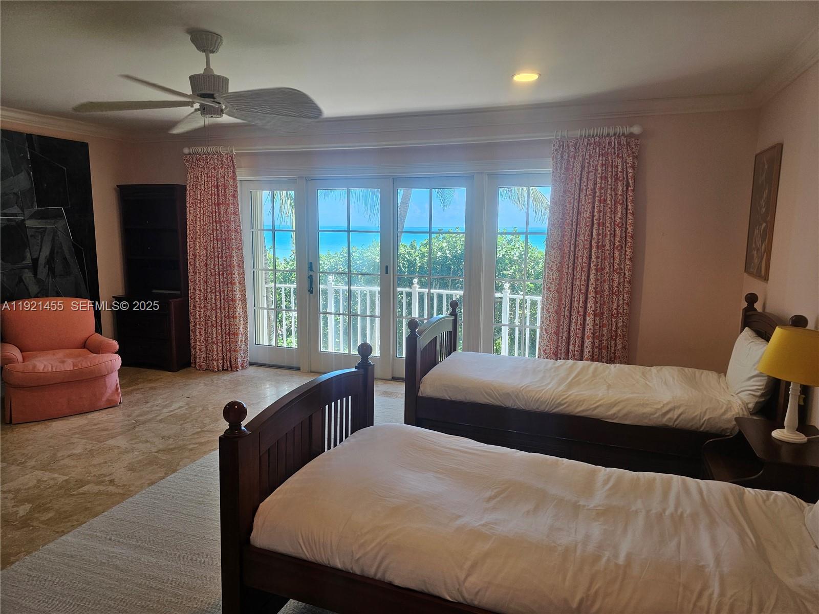 404 South Beach Road, Unit 404 Jupiter Island, FL 33455 - Photo 21 of 23 a bedroom with a bed and glass walk in closet