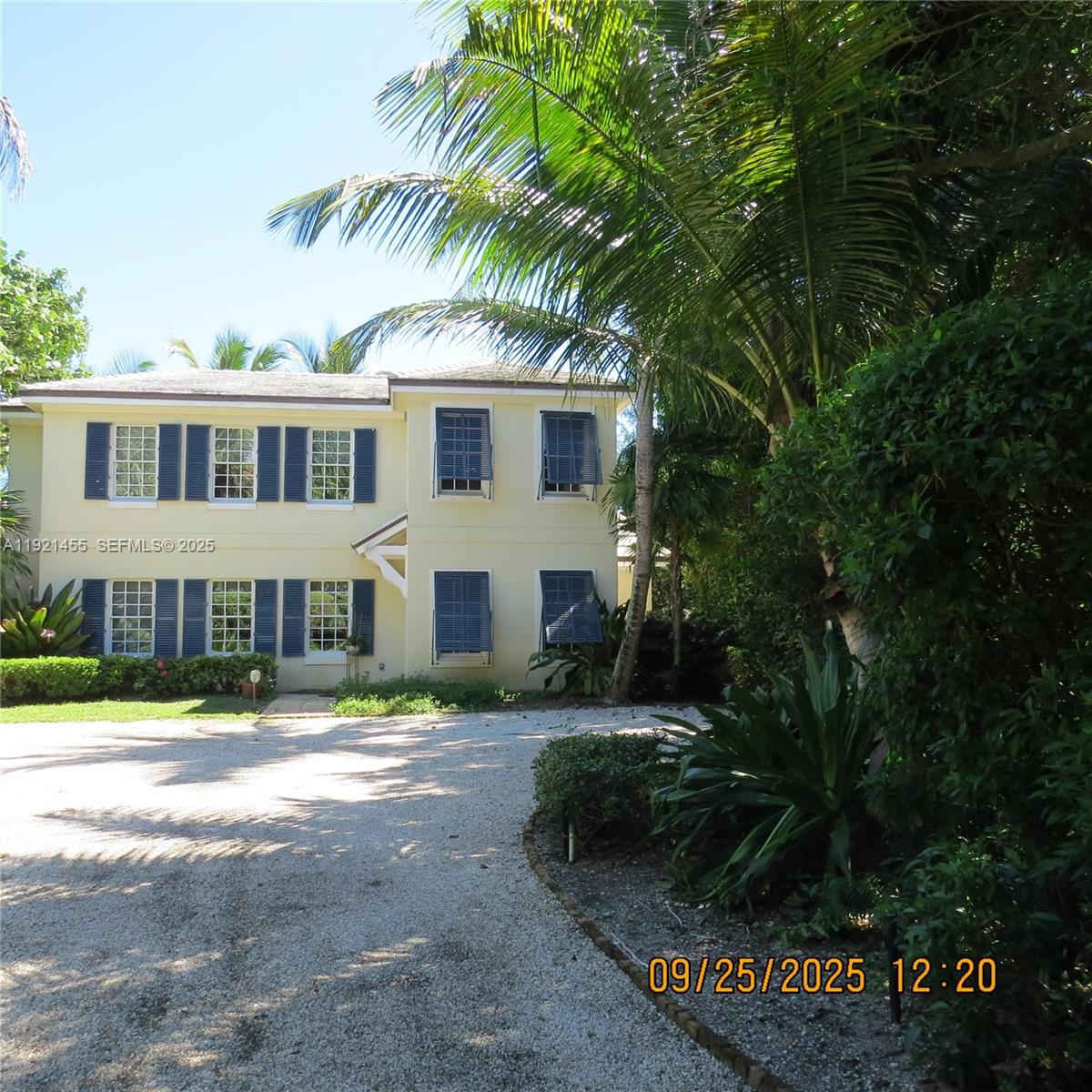 404 South Beach Road, Unit 404 Jupiter Island, FL 33455 - Photo 3 of 23 a front view of a house with a yard